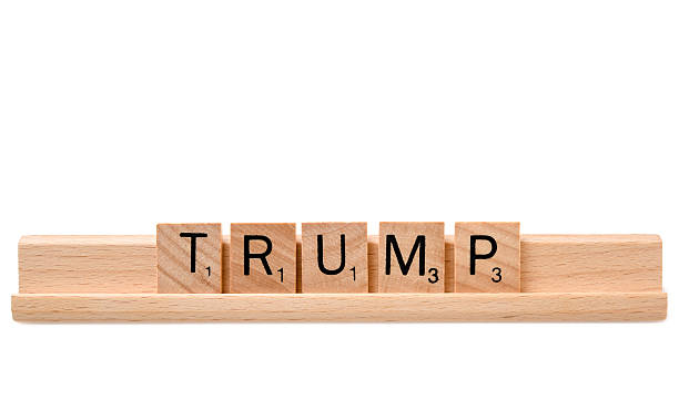 TRUMP Miami, Florida, USA - December 5, 2015: Word "Trump" in Scrabble tiles in a wooden platform on white background. Scrabble is a fun and educational game distributed by Hasbro rnc convention stock pictures, royalty-free photos & images