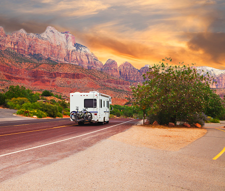 Motor home on the road at sunset touring Utah, USA