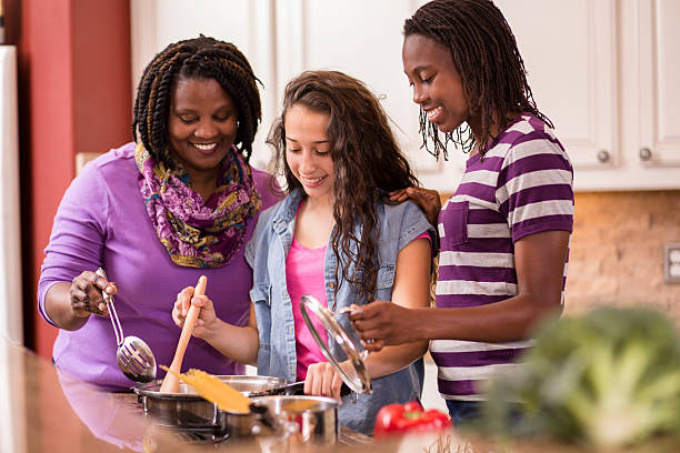 istock Multi-ethnic family at home cooking together in kitchen. 580126546