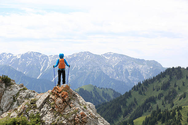 istock successful woman backpacke hiking  on mountain peak 580126622