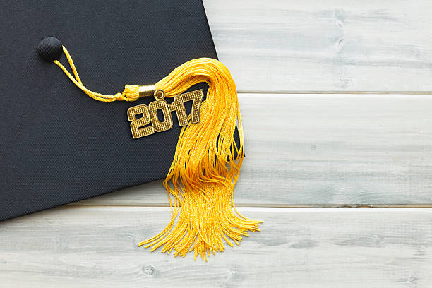 istock Black and Gold 2017 Graduation White Wood Background 580128236