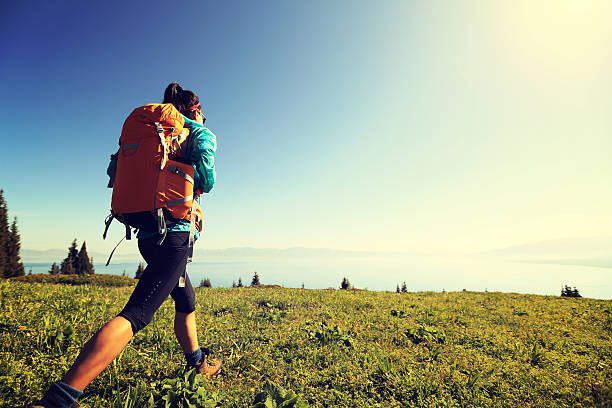 istock young woman backpacker hiking on beautiful mountain peak 580129810