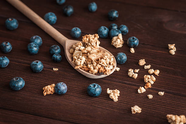istock muesli with blueberries on a wooden spoon 580130296