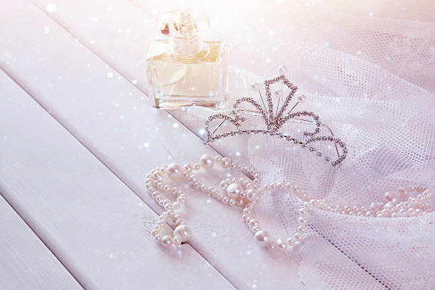 istock White pearls necklace, diamond tiara and perfume bottle 580133822