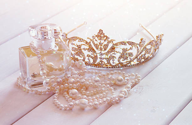 White pearls necklace, diamond tiara and perfume bottle