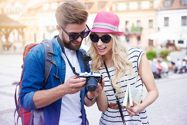istock Happy couple looking on pictures from vacation 580136614
