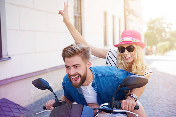 istock Couple driving a scooter at the city 580136890