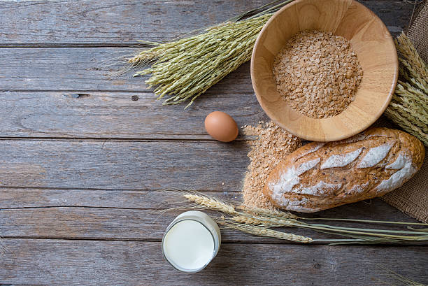 istock fresh bread and wheat on the old wooden 582256416