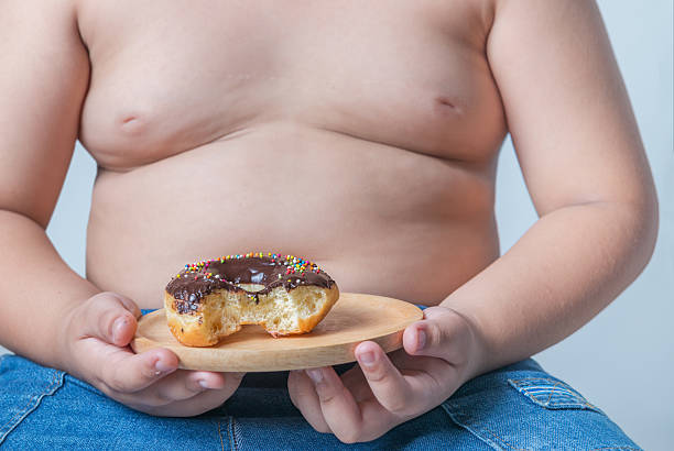 istock donut in obese fat boy 582256936