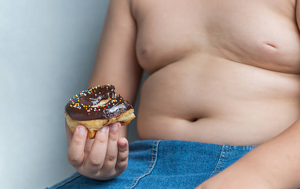 istock donut in obese fat boy 582256986