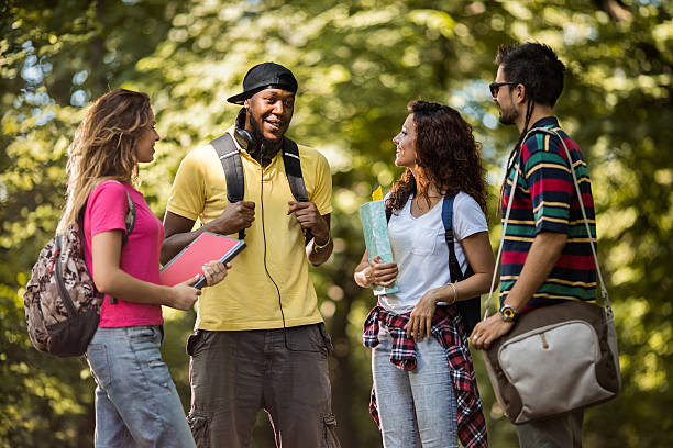istock Group of students standing in the park and communicating. 582257080