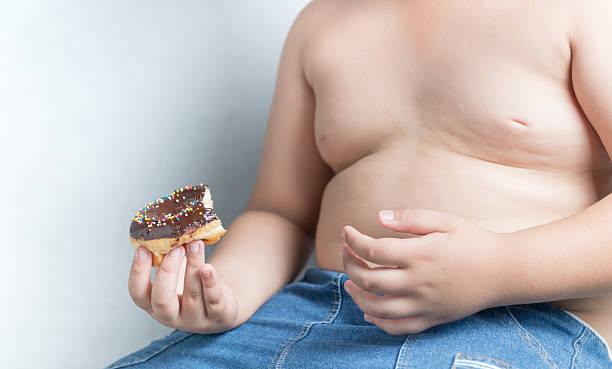istock donut in obese fat boy 582257116