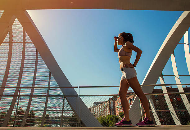 istock Female runner scanning the horizon 582257808