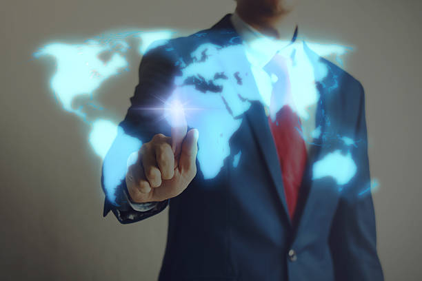 istock Businessman touching blue virtual world map on screen 582257924