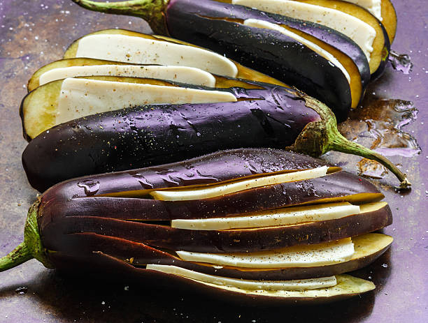 istock Raw eggplant with cheese, spices, olive oil ready for baking 582258010