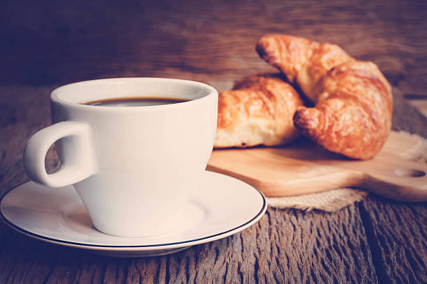 istock Continental breakfast with coffee and croissant 582258012