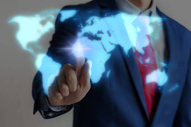 istock Businessman touching blue virtual world map on screen 582258026