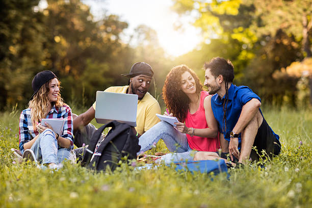 istock Hipster students learning in nature and talking to each other. 582258380