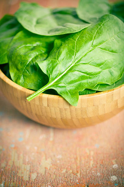 istock green spinach leaves in bowl 582258706