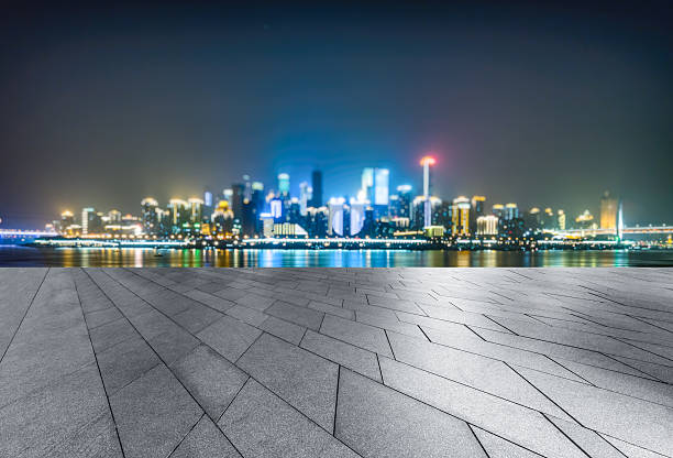 istock empty tiled floor before city skyline and cityscape 582258944