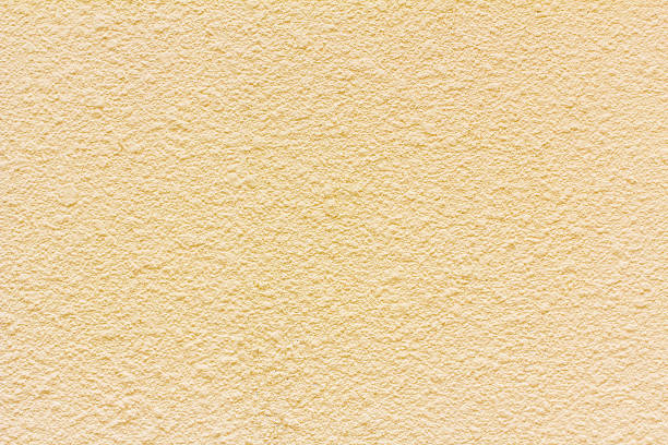 istock Yellow grunge cement wall, textured background 582258976
