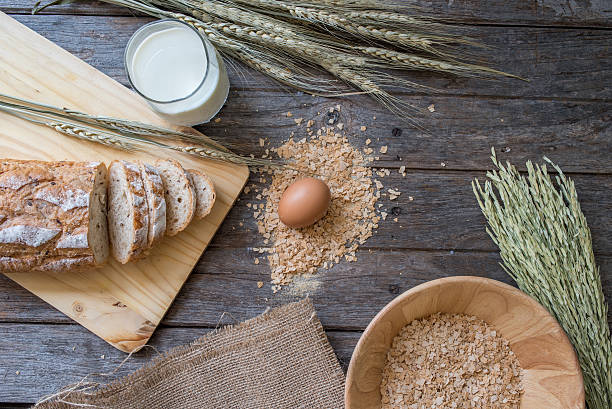 istock fresh bread and wheat on the old wooden 582259472