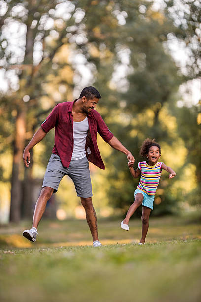 istock Happy father and daughter having fun in the park. 582259528