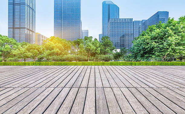 istock empty wooden floor with modern buildings background 582260054