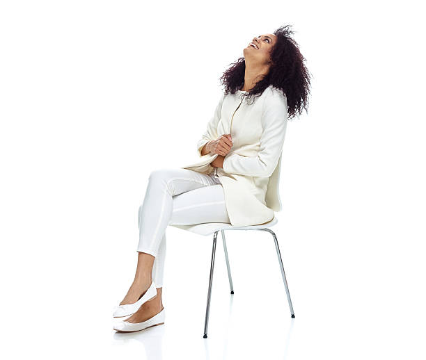 istock Cheerful woman sitting and looking up 582260736