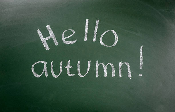 istock Hello autumn - inscription on blackboard with chalk 582261108
