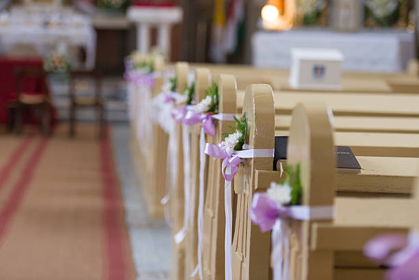 istock Church bench decoration with rose bow 582262240