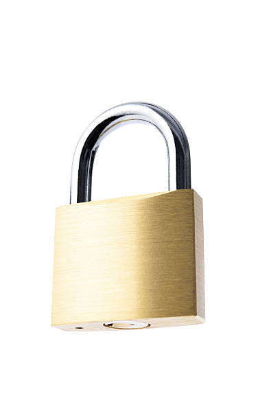 istock Low angle view of locked new padlock against white background 582262260