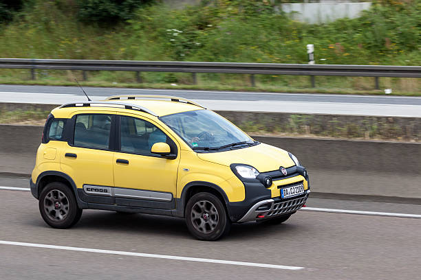 Fiat Panda Cross Frankfurt, Germany - July 12, 2016: Yellow Fiat Panda Cross SUV driving on the highway  little fiat car stock pictures, royalty-free photos & images