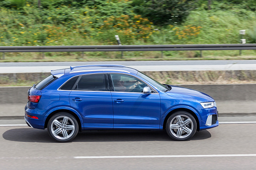 Frankfurt, Germany - July 12, 2016: Blue AUDI Q3 luxury SUV driving on the highway 