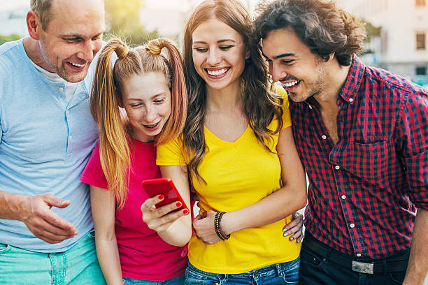 istock Group of people looking at a phone. 582265166