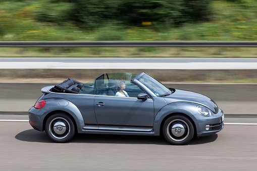 Frankfurt, Germany - July 12, 2016: Volkswagen Beetle Convertible driving on the highway  