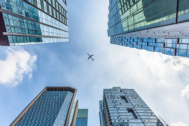 istock plane flying over the skyscrapers 582266640