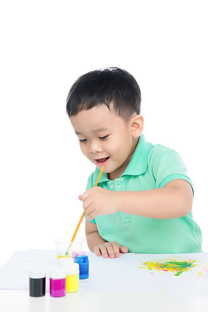 istock Happy boy painting with colored 582268320