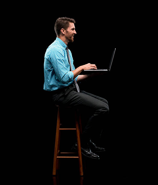 istock Smiling businessman typing on laptop 582268868
