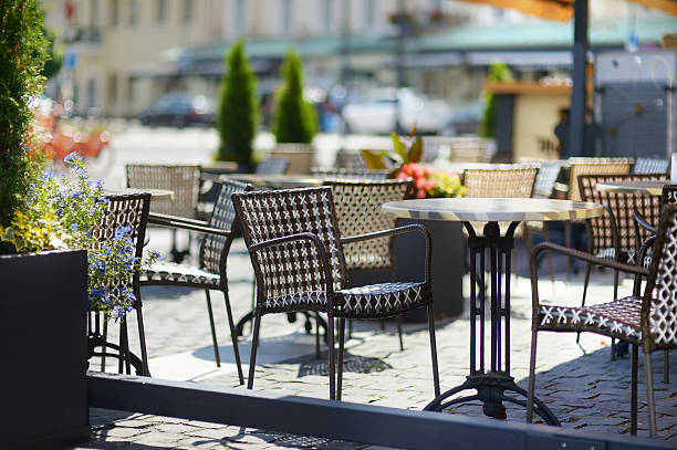 istock Empty chiars in outdoor cafe on summer day 582269254
