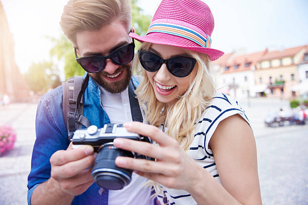 istock Couple looking on camera screen with pictures 582270614