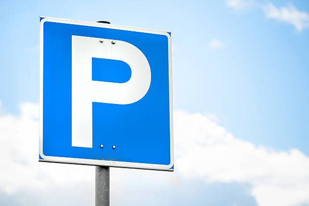 istock Blue square parking road sign over bright sky 582270870