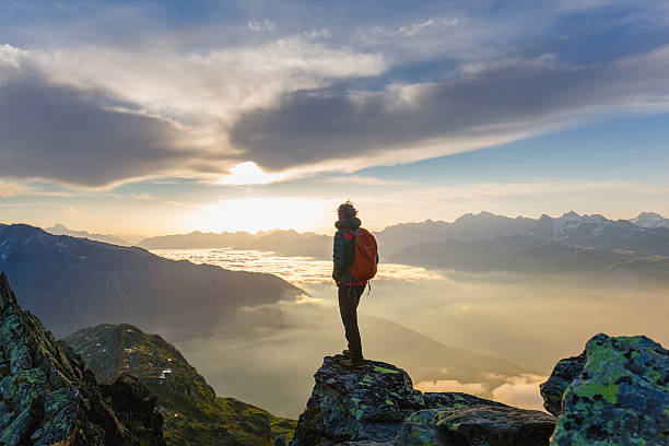 istock Hiker on mountains enjoy sunrise 582272330