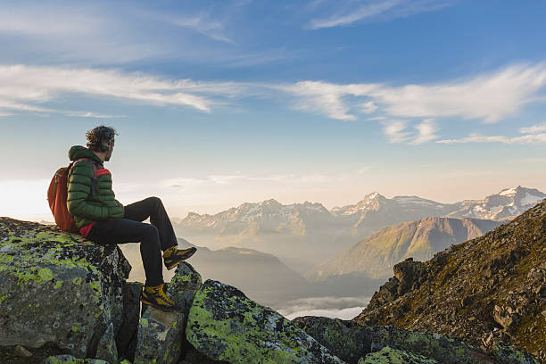 istock Hiker on top looks mountain panorama 582272402