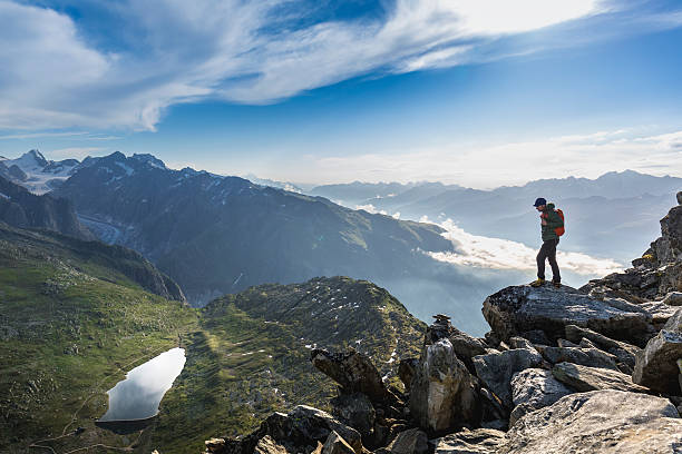 istock Hiker on top looks mountain panorama 582272468