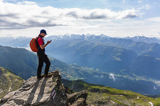 istock Hiker on mountains checks his smartphone 582272508