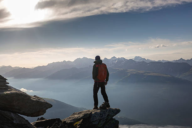 istock Hiker on mountains enjoy sunrise 582272510