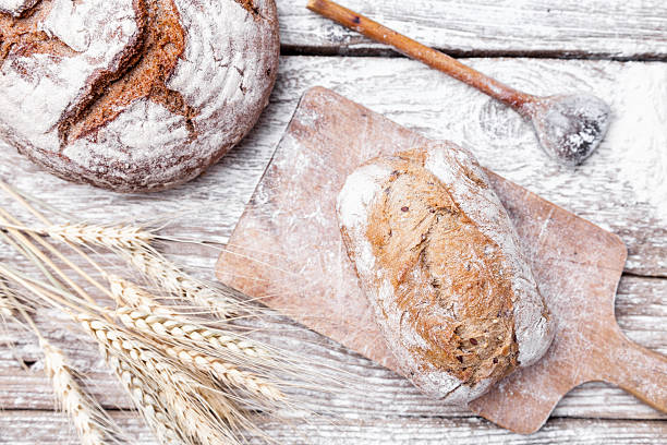 istock Delicious fresh bread on wooden background 582272790