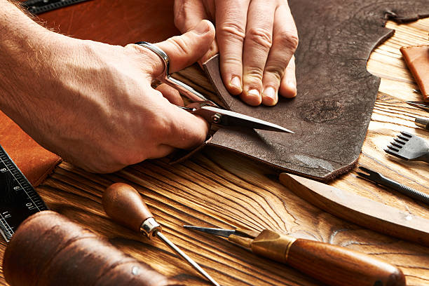 Man working with leather Man working with leather using crafting DIY tools craftsperson stock pictures, royalty-free photos & images