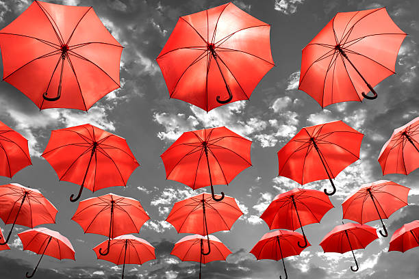 umbrella standing out from the crowd unique concept stock photo